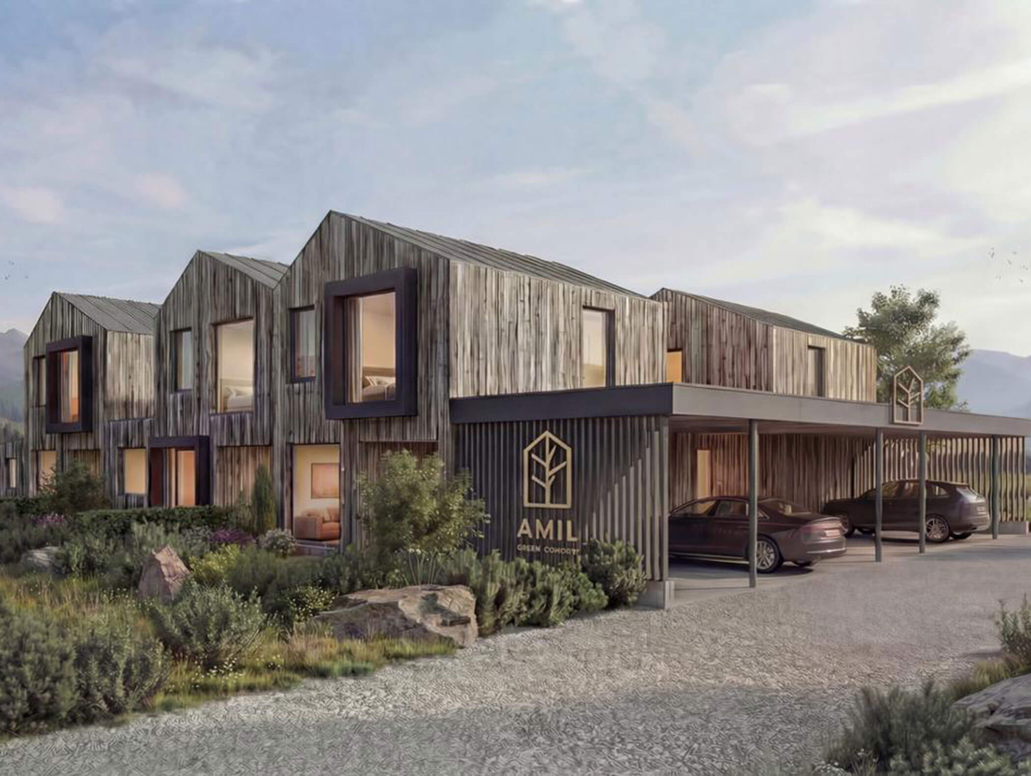 Moderno edificio in legno con grandi finestre, tettoie e auto parcheggiate, circondato dal verde e dalle montagne. - AMIL chalets dolomites